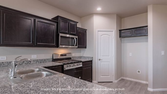 Open concept kitchen with stainless steel appliances, shaker style cabinets, and elevated finishes