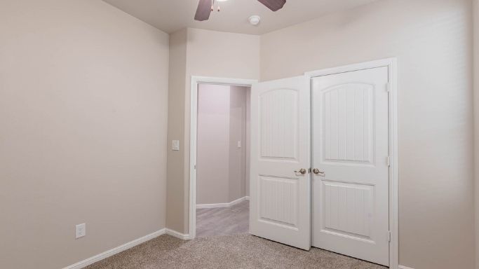 Guest bedroom 4 with plush carpet and side window