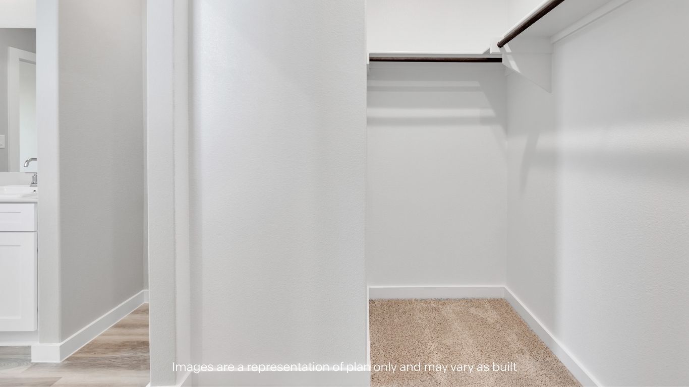 The spacious walk-in closet offers plenty of room for storage and organization.