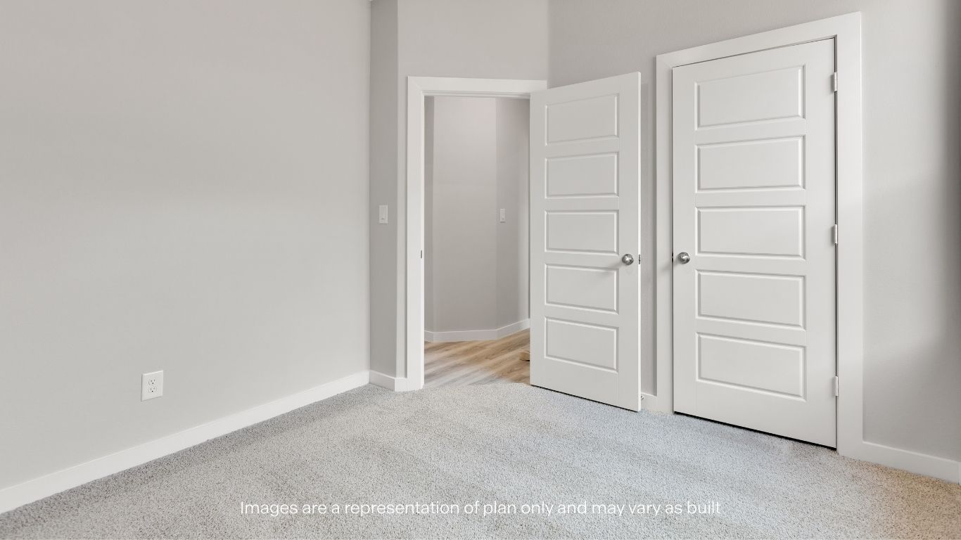 A bright secondary bedroom designed for comfort and flexibility.