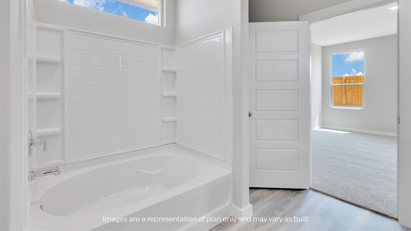 Relax and unwind in the primary bath featuring a soaking tub.