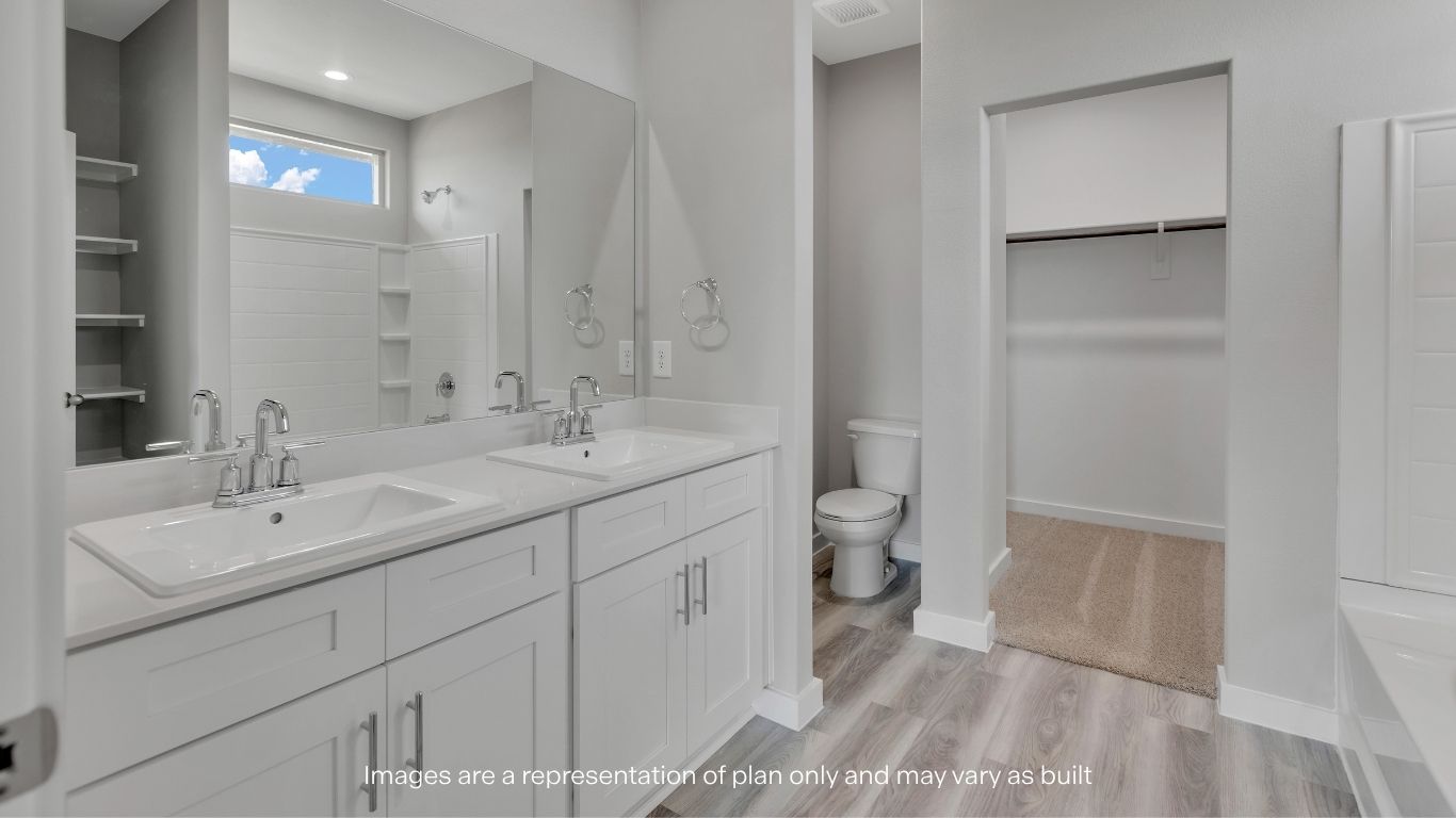 Dual vanities and a large walk-in closet complete the primary suite.