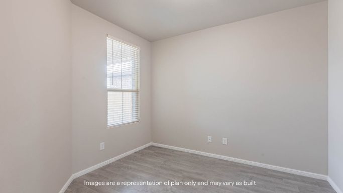 Guest bedroom 2 with side window and plush carpet floor