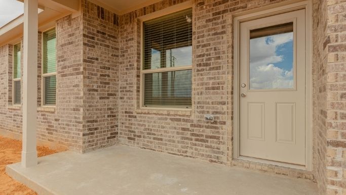 Covered back patio area overlooking spacious backyard