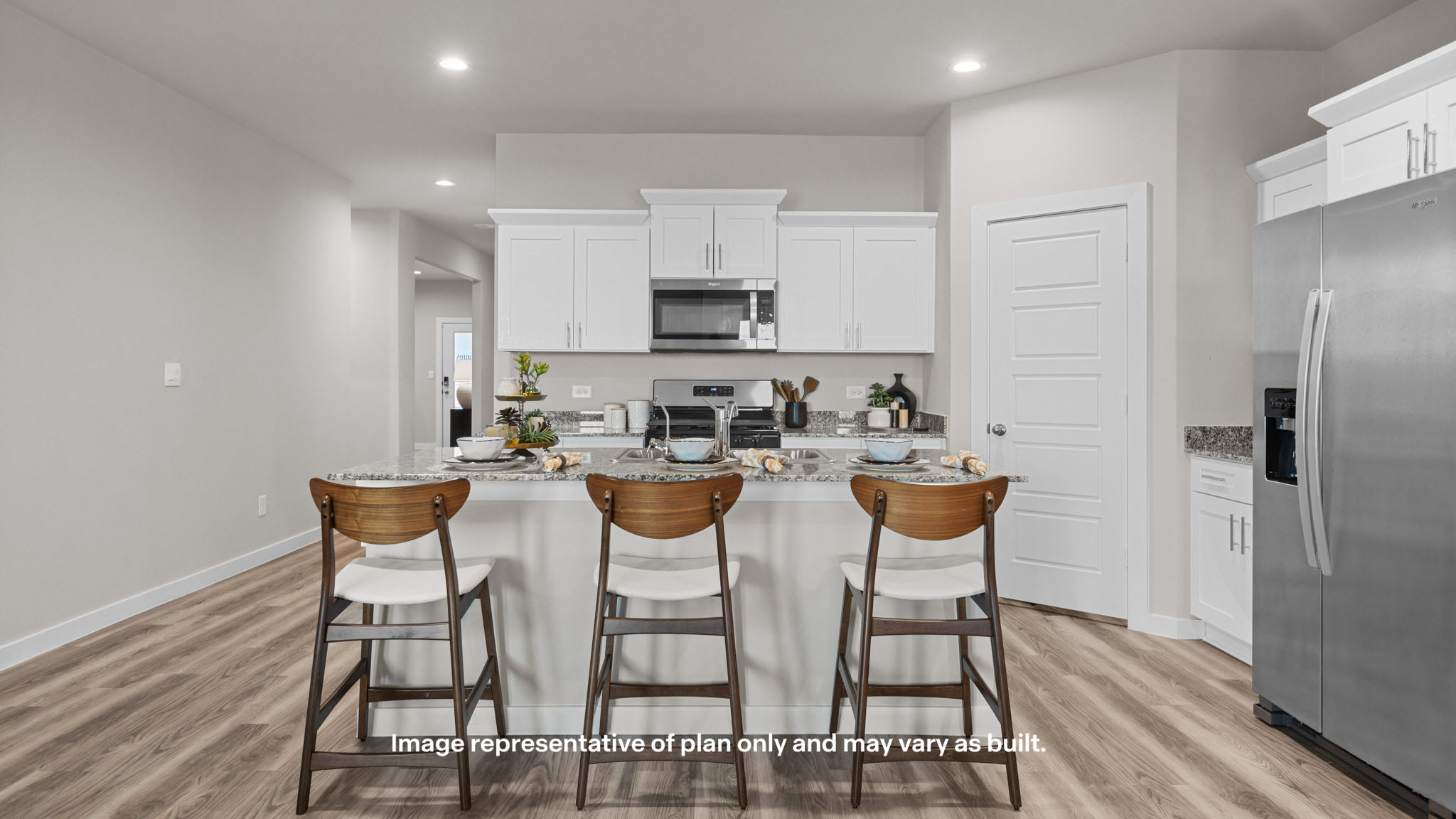 Kitchen with stainless steel appliances, shaker style cabinets, and elevated finishes