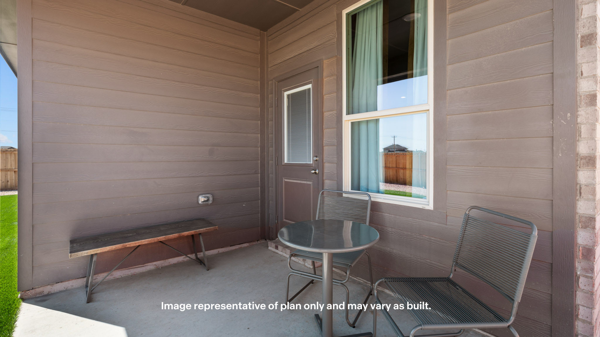 Covered back patio area overlooking spacious backyard
