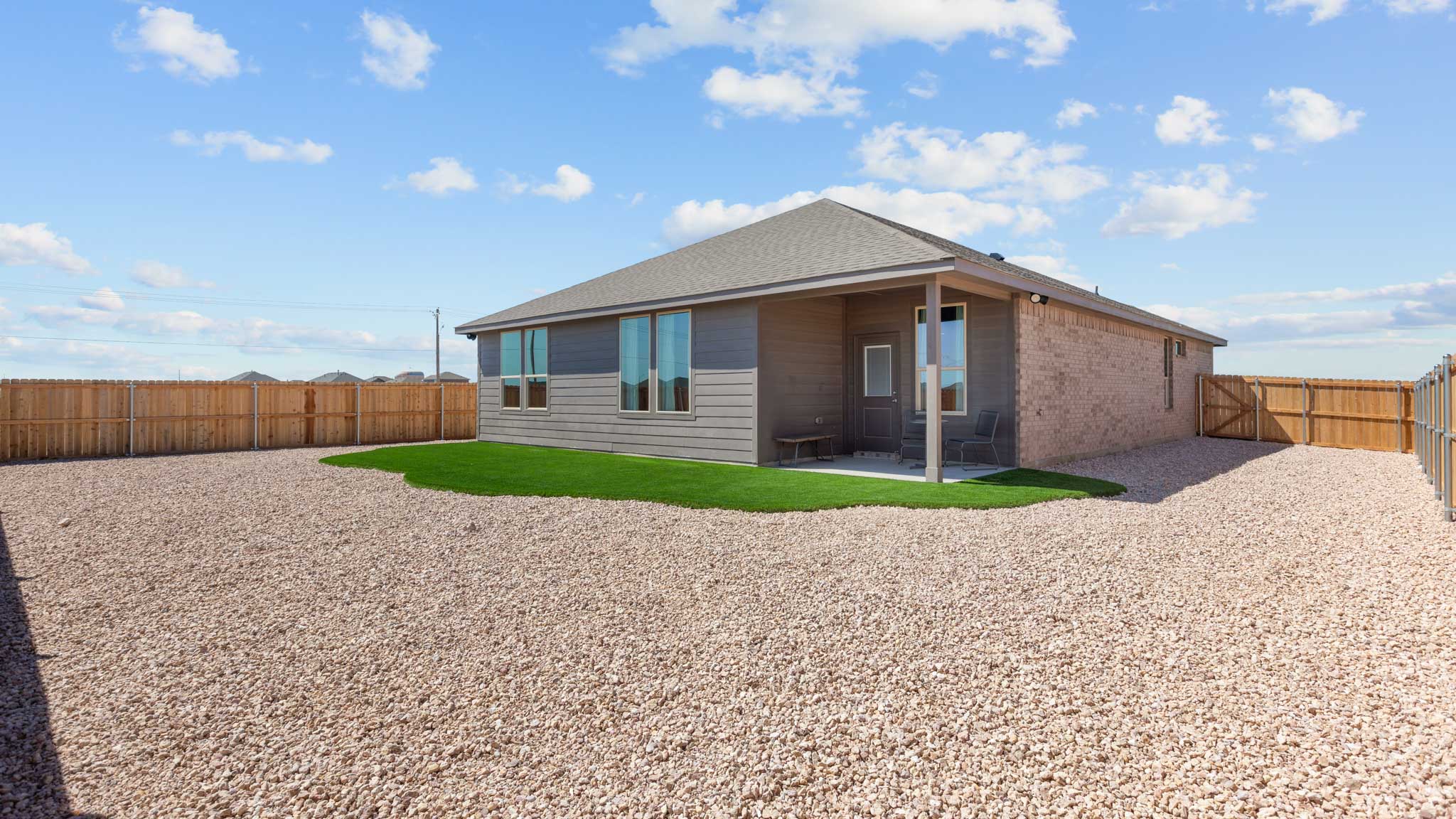 Covered back patio area overlooking spacious backyard