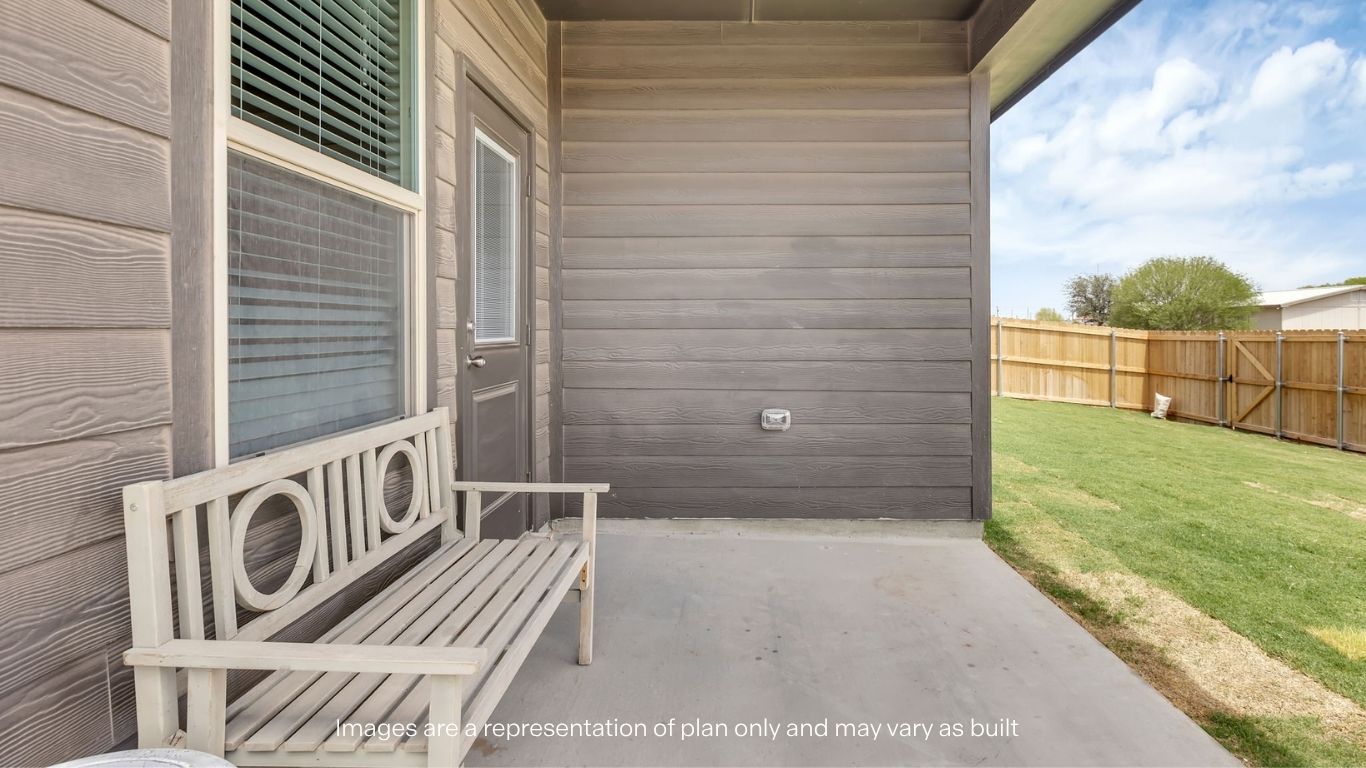 Covered back patio area overlooking spacious backyard