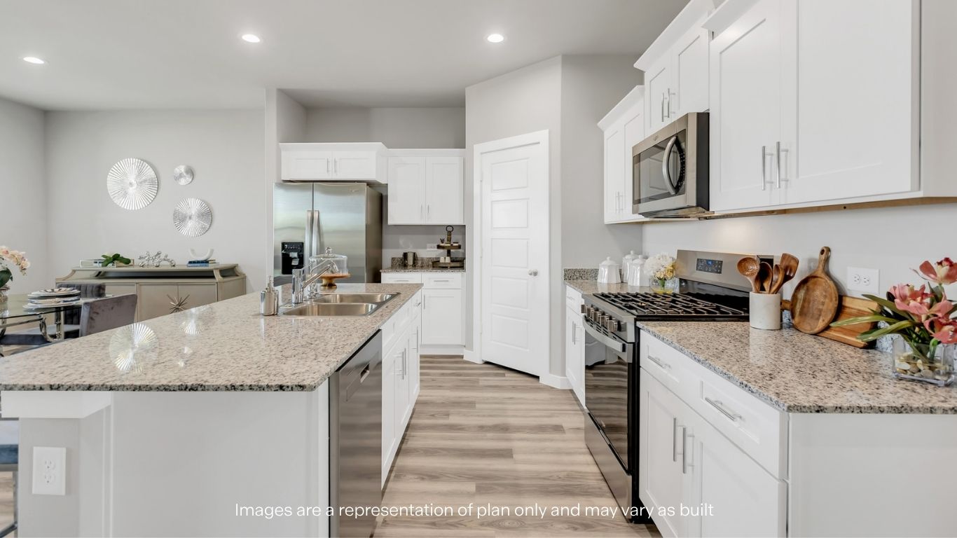 Open concept kitchen with stainless steel appliances, shaker style cabinets, and elevated finishes