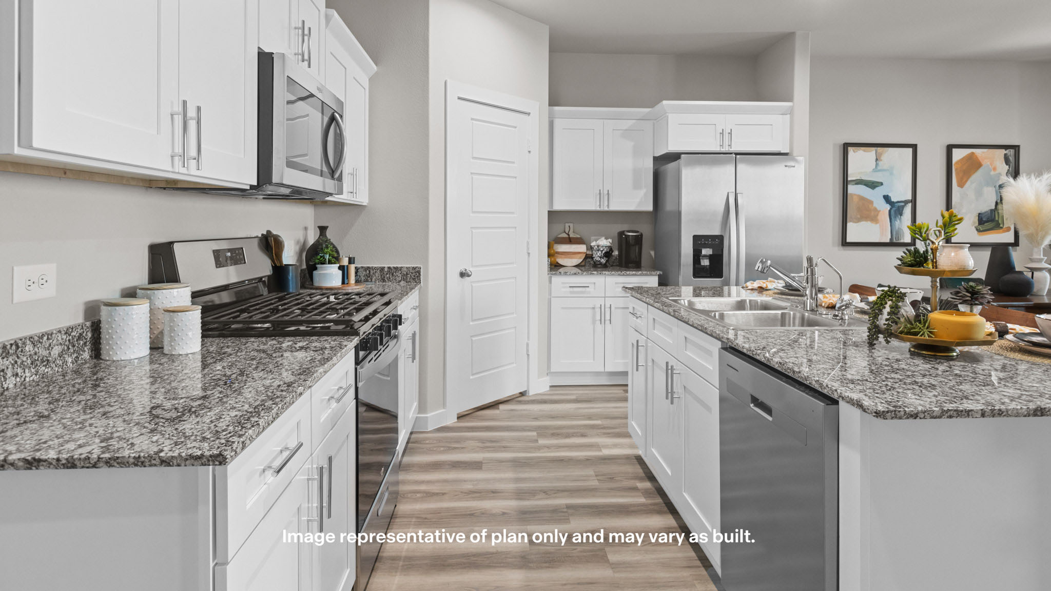 Open concept kitchen with stainless steel appliances, shaker style cabinets, and elevated finishes