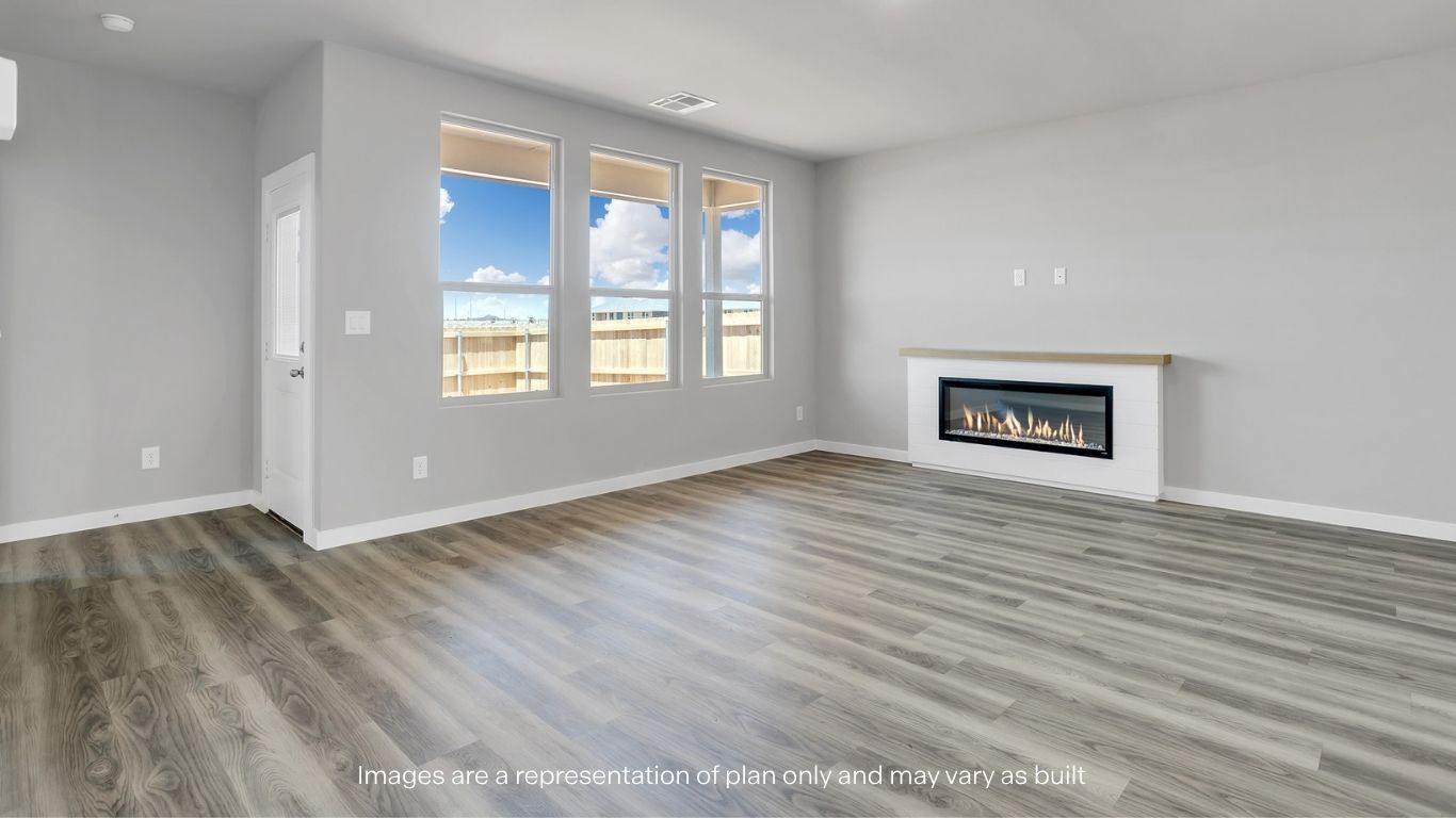 A living room area with large windows and a sleek built-in fireplace.