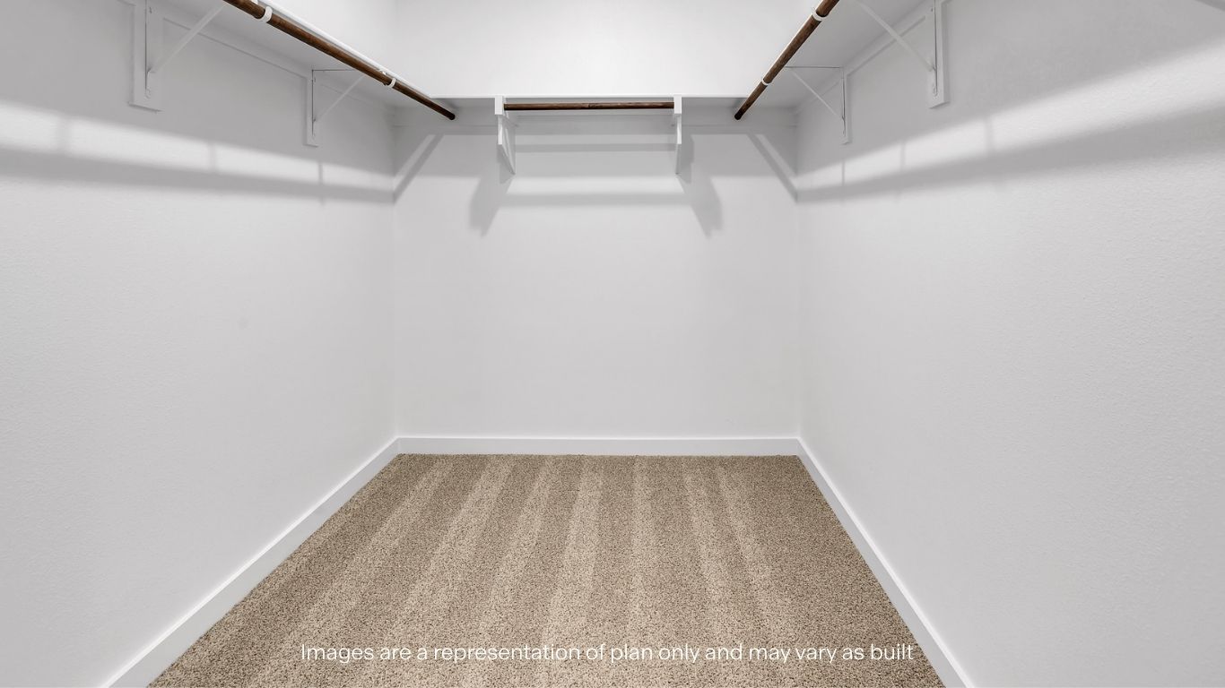 A large walk-in closet with built-in shelving and hanging space.