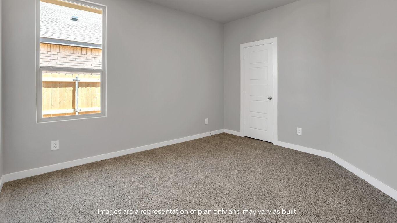Another view of a bedroom space featuring a window and closet door for added functionality.