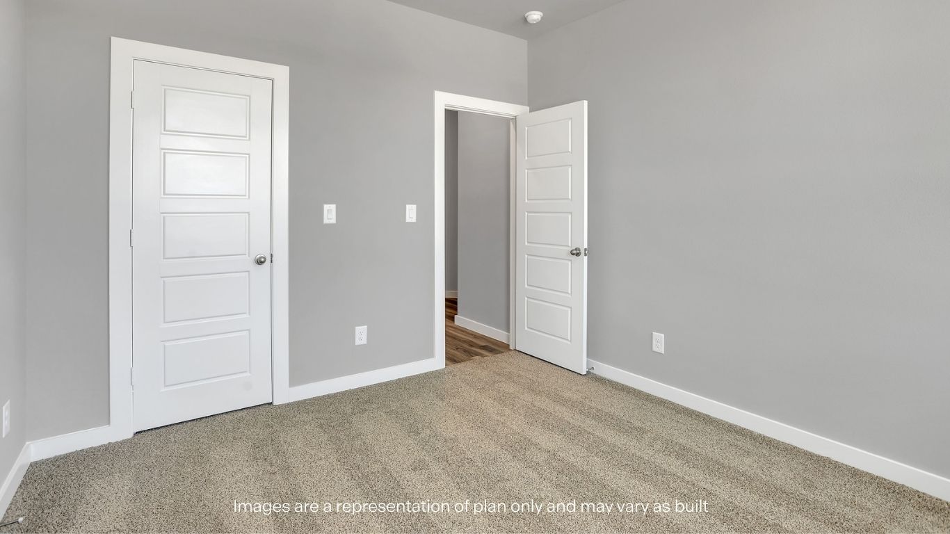 Another view of the bedroom showcasing closet space and clean, neutral finishes.