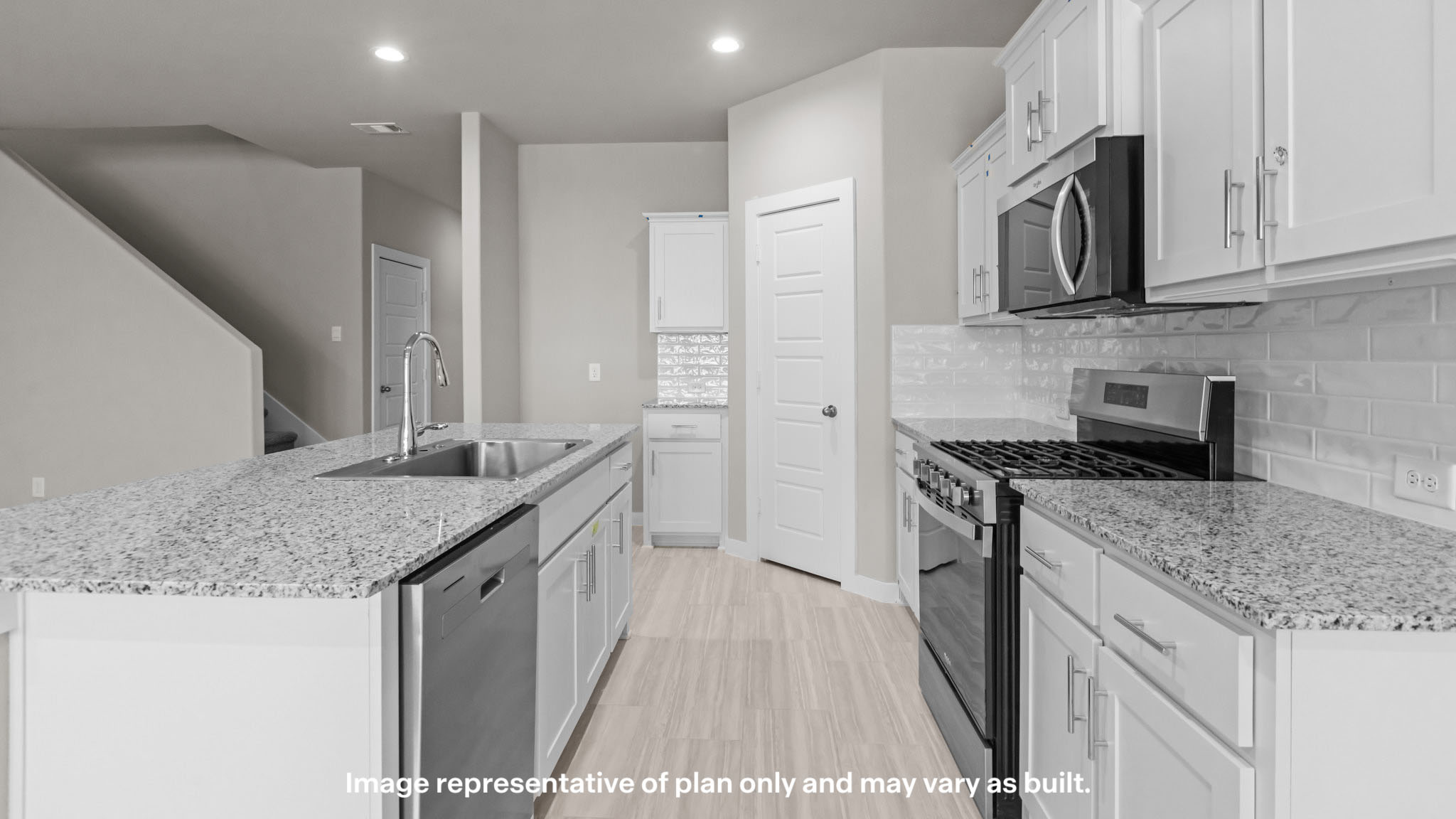 Open concept kitchen with stainless steel appliances, shaker style cabinets, and elevated finishes