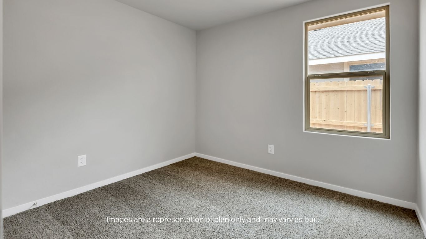Additional bedroom with soft carpeting, neutral color palette, and roomy closet space.