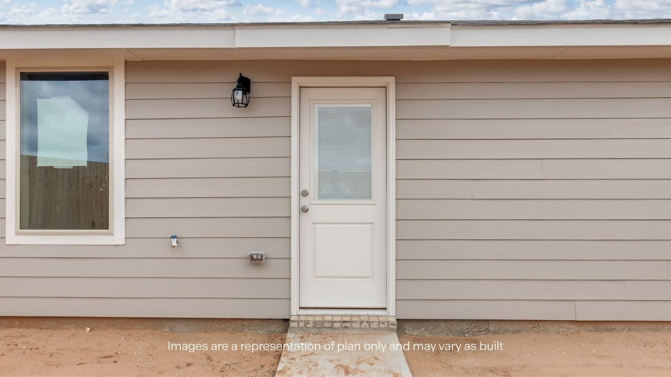 Rear exterior featuring backyard access, durable siding, and a convenient patio entry for outdoor enjoyment.