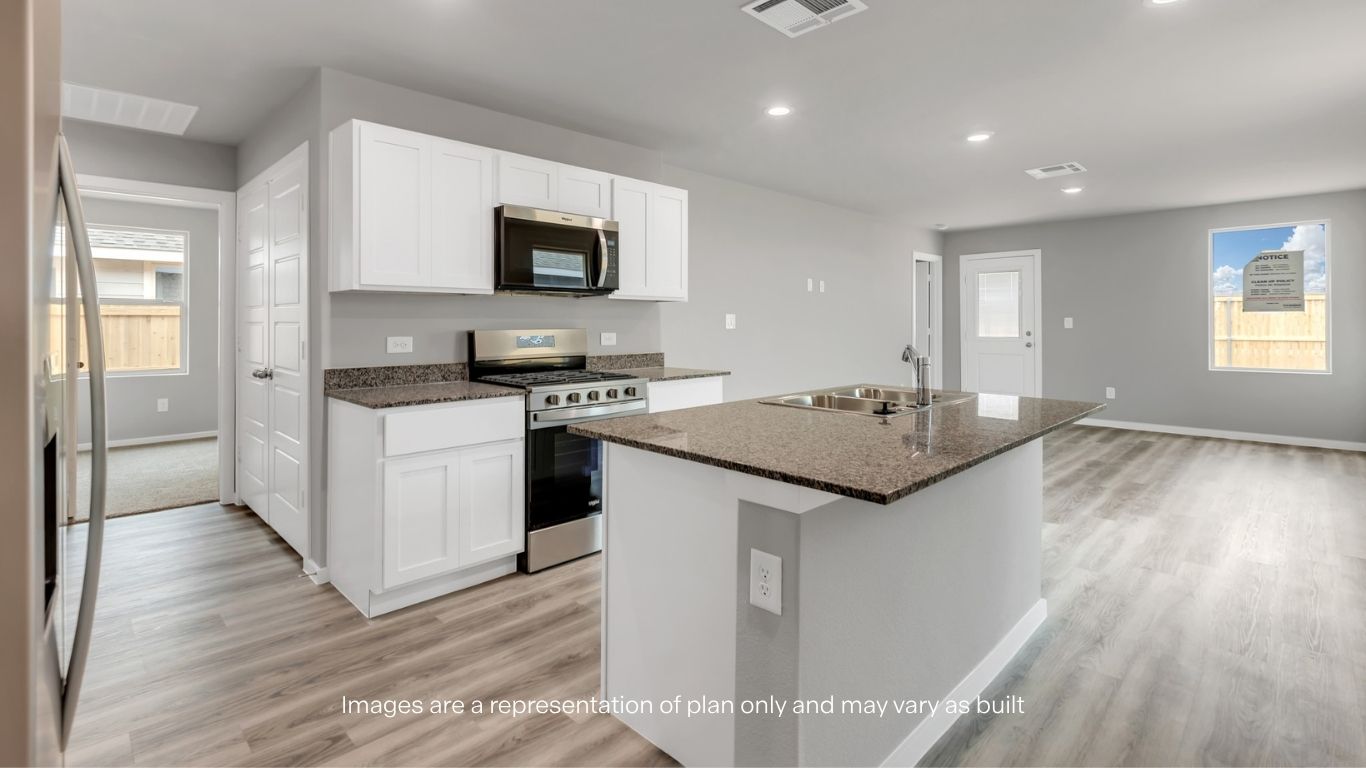 Bright open-concept kitchen overlooking the living and dining spaces, perfect for entertaining and everyday living.