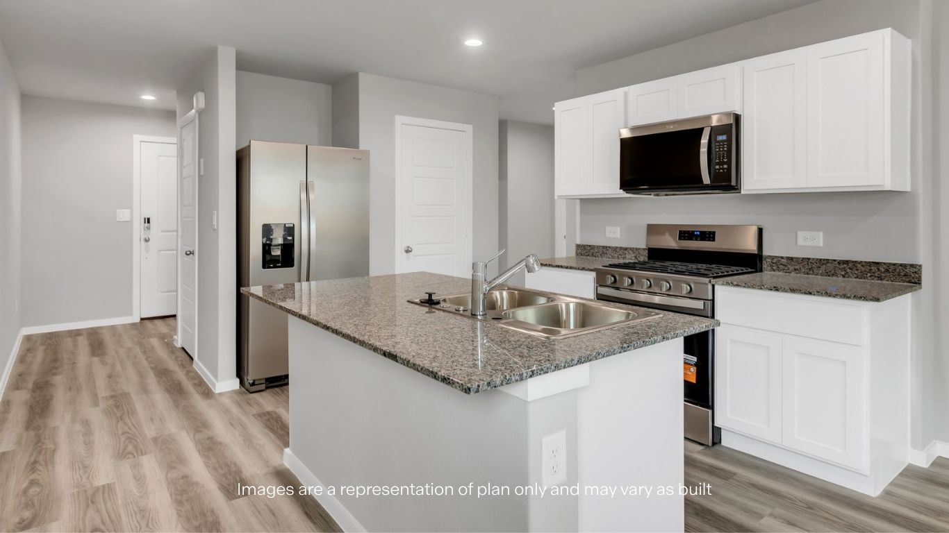 Spacious kitchen island with double-basin sink, ample prep space, and seamless flow into the main living area.