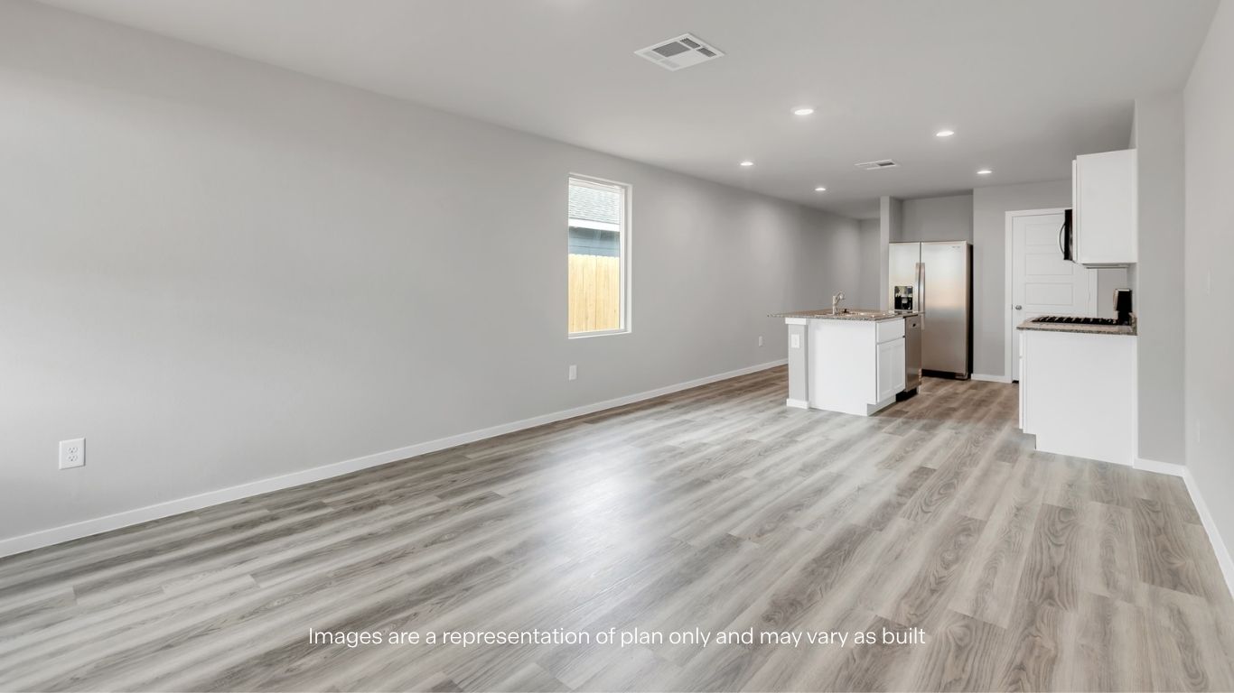 Large open living and dining area with durable flooring, recessed lighting, and abundant natural light.