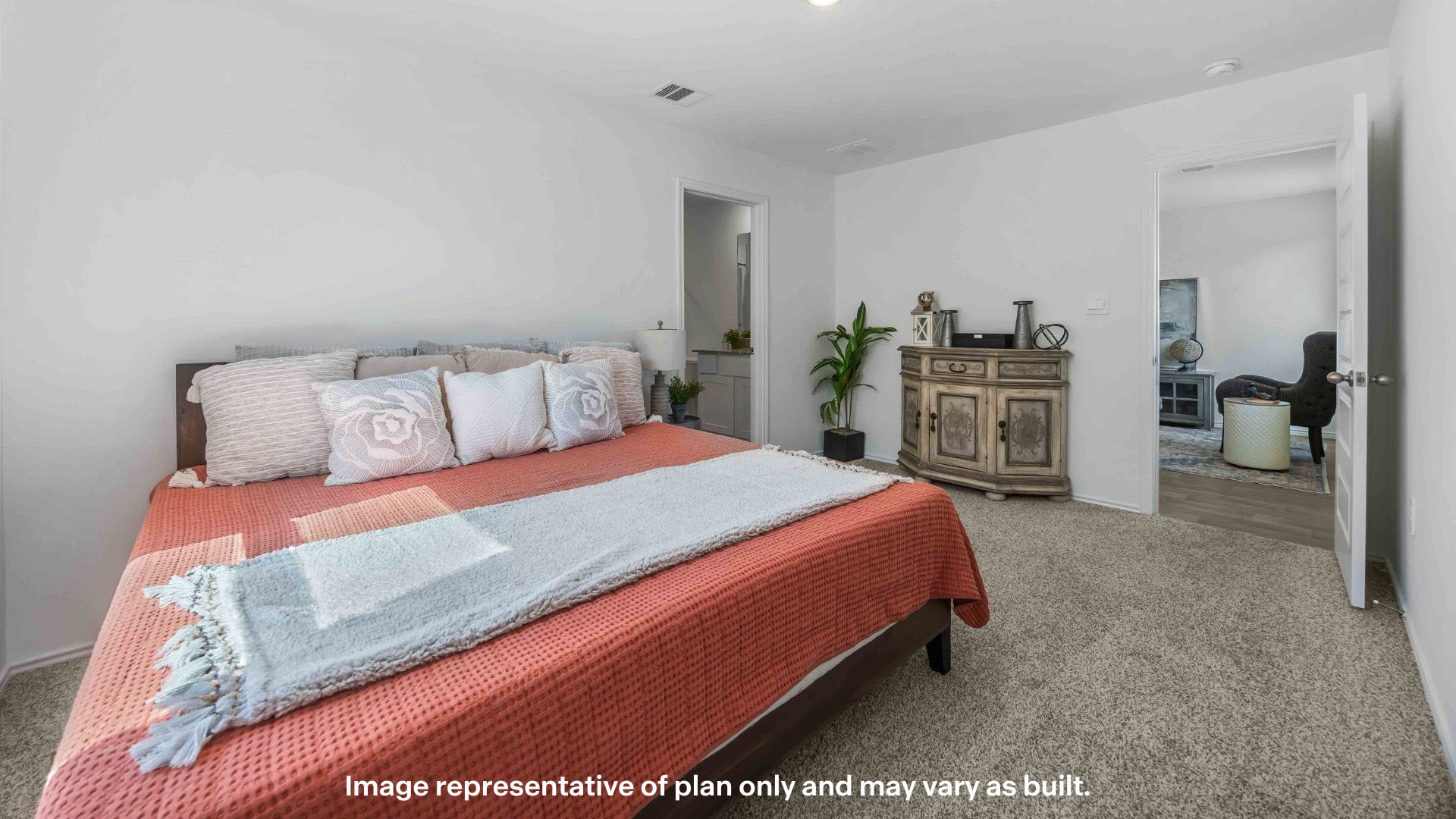 Primary bedroom with plush carpet floors and light allowing windows