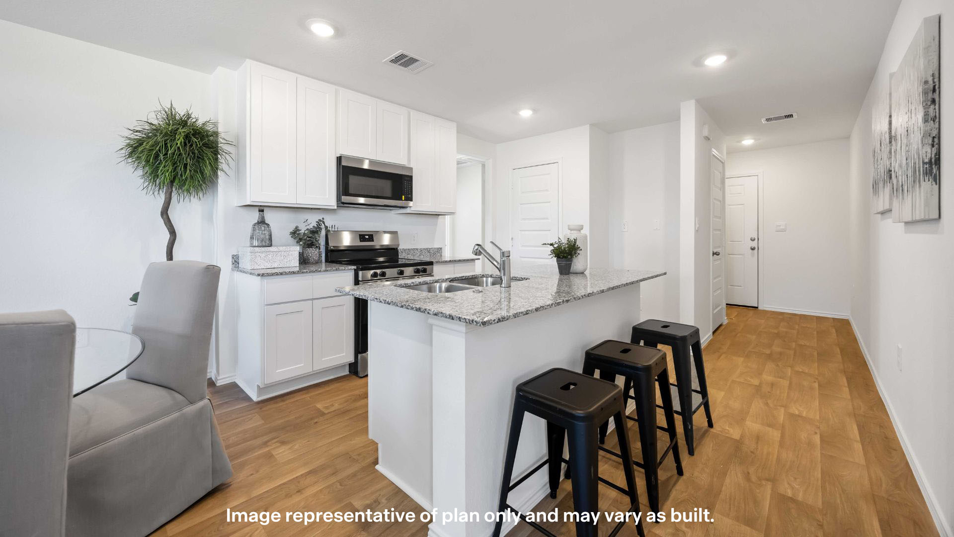 Open concept kitchen with stainless steel appliances, shaker style cabinets, and elevated finishes