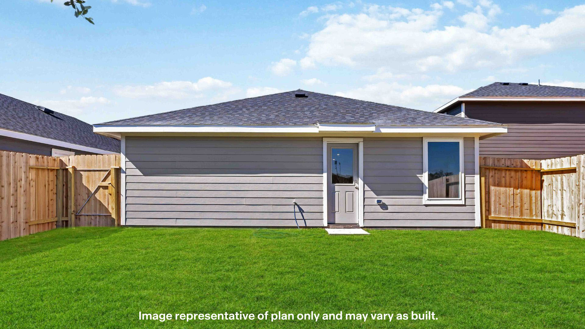 Covered back patio area overlooking spacious backyard