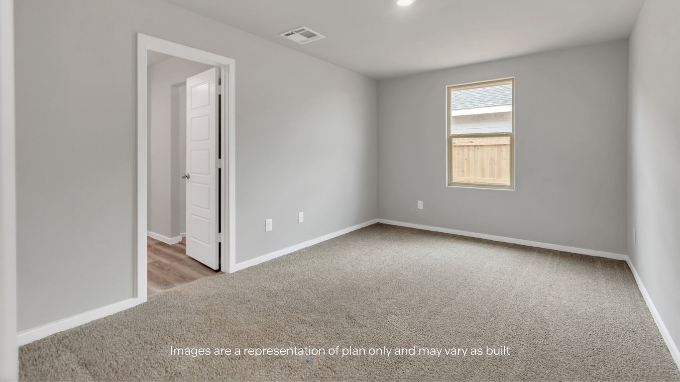 Comfortable secondary bedroom with plush carpeting.