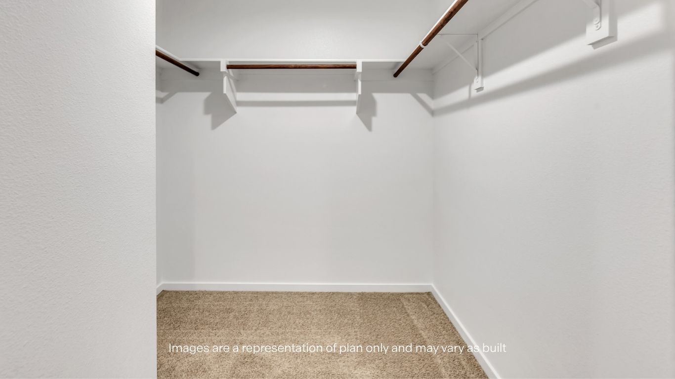 Spacious primary closet with plenty of storage space.