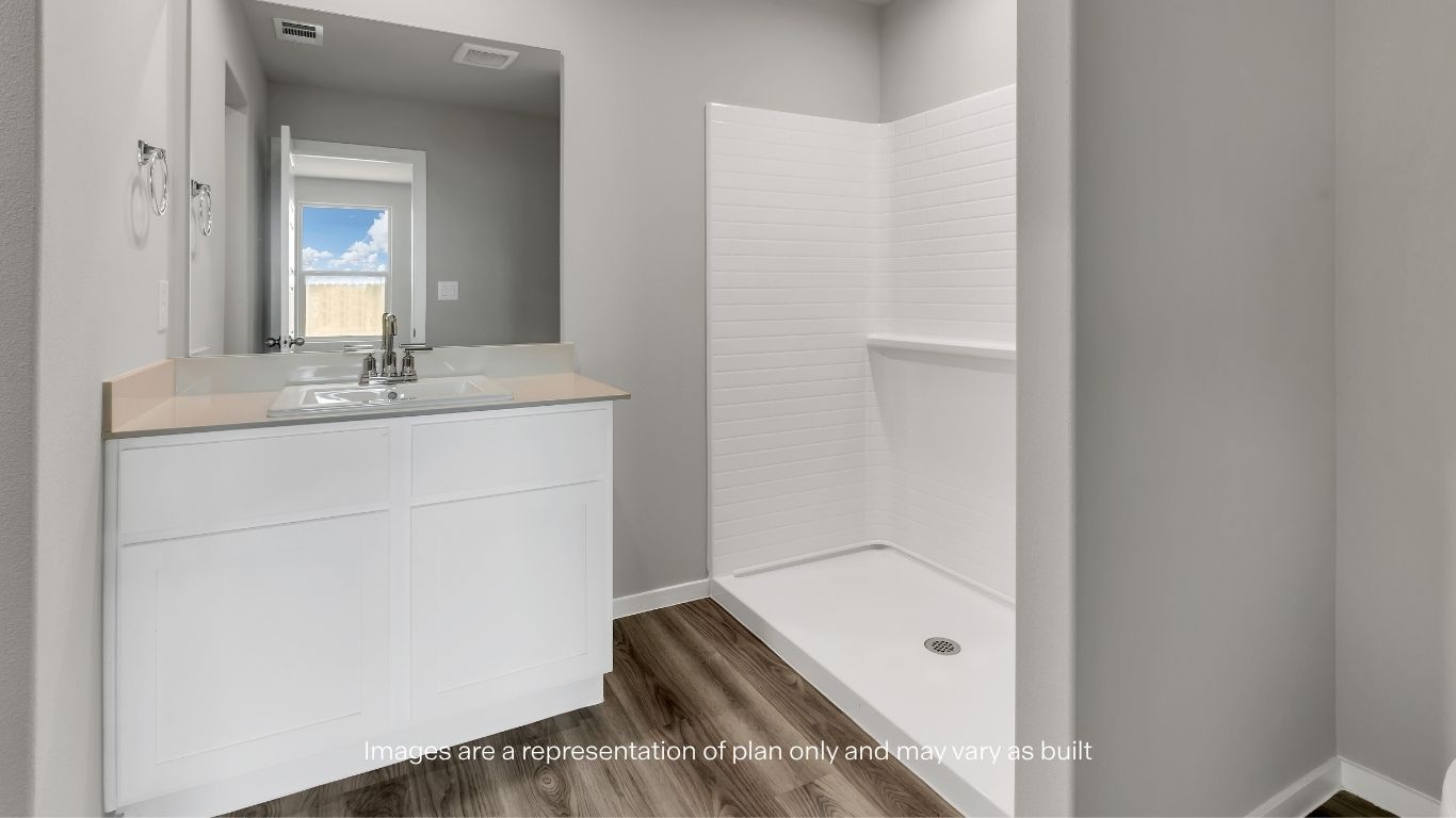 Enjoy a modern primary bath featuring a spacious vanity and a sleek walk-in shower.