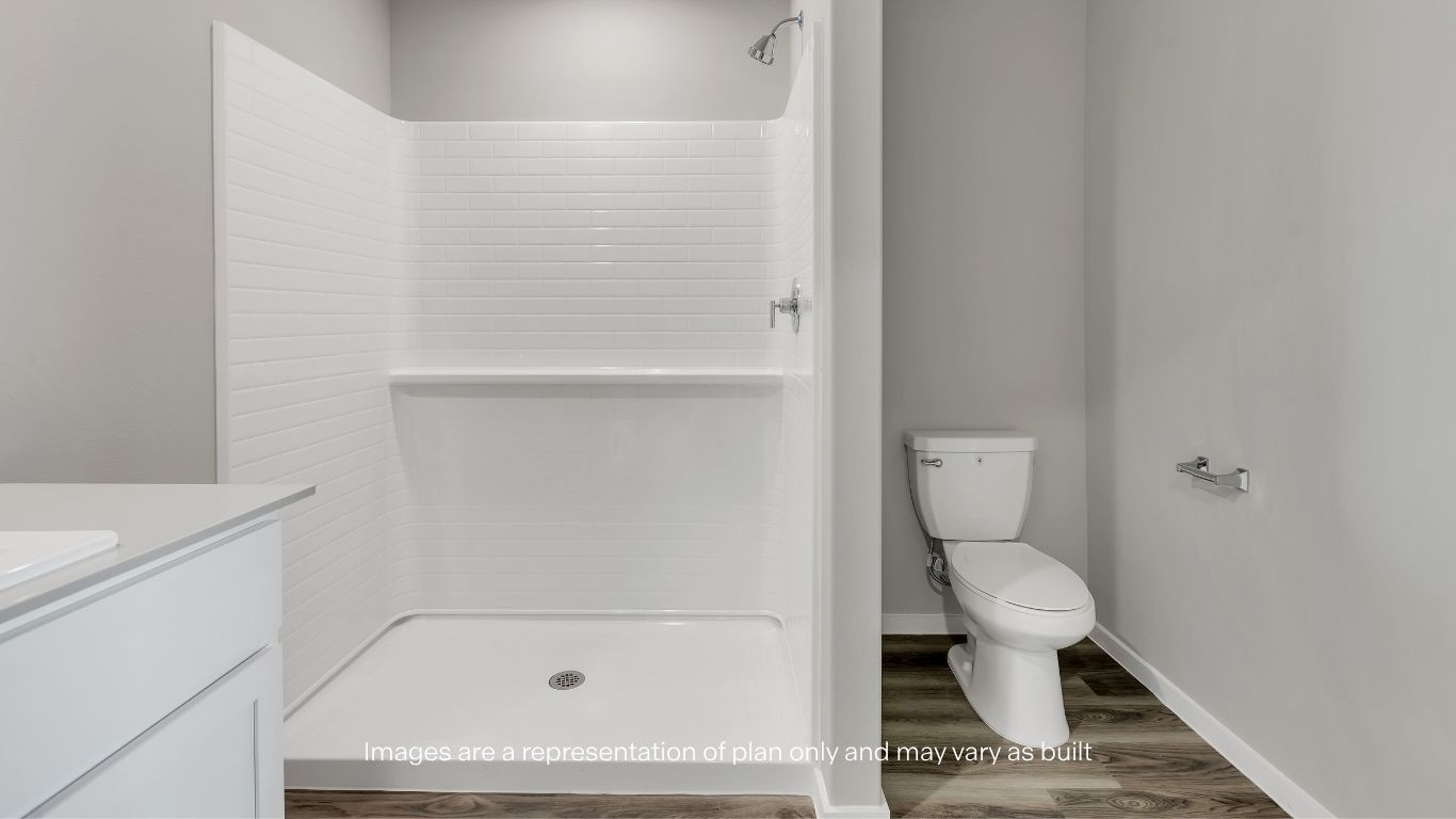 The thoughtfully designed primary bathroom combines convenience and comfort with contemporary finishes.