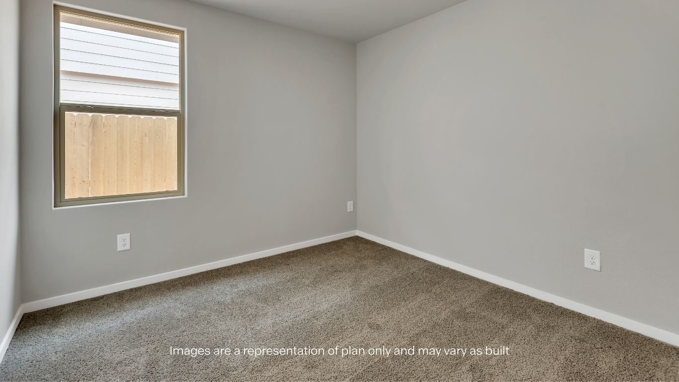 The secondary bedroom offers a versatile space ideal for guests, family members, or a home office.