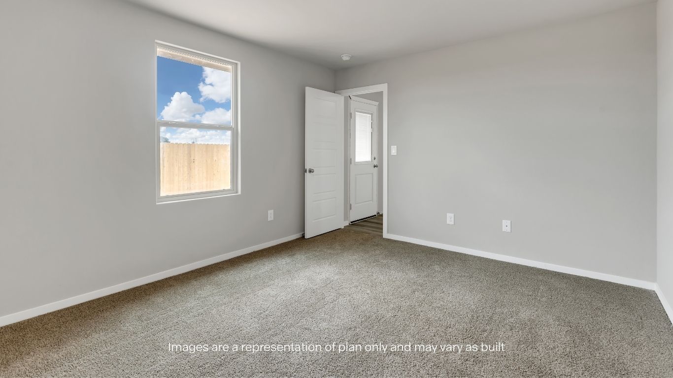 The private primary suite offers a comfortable retreat with ample space and natural light.