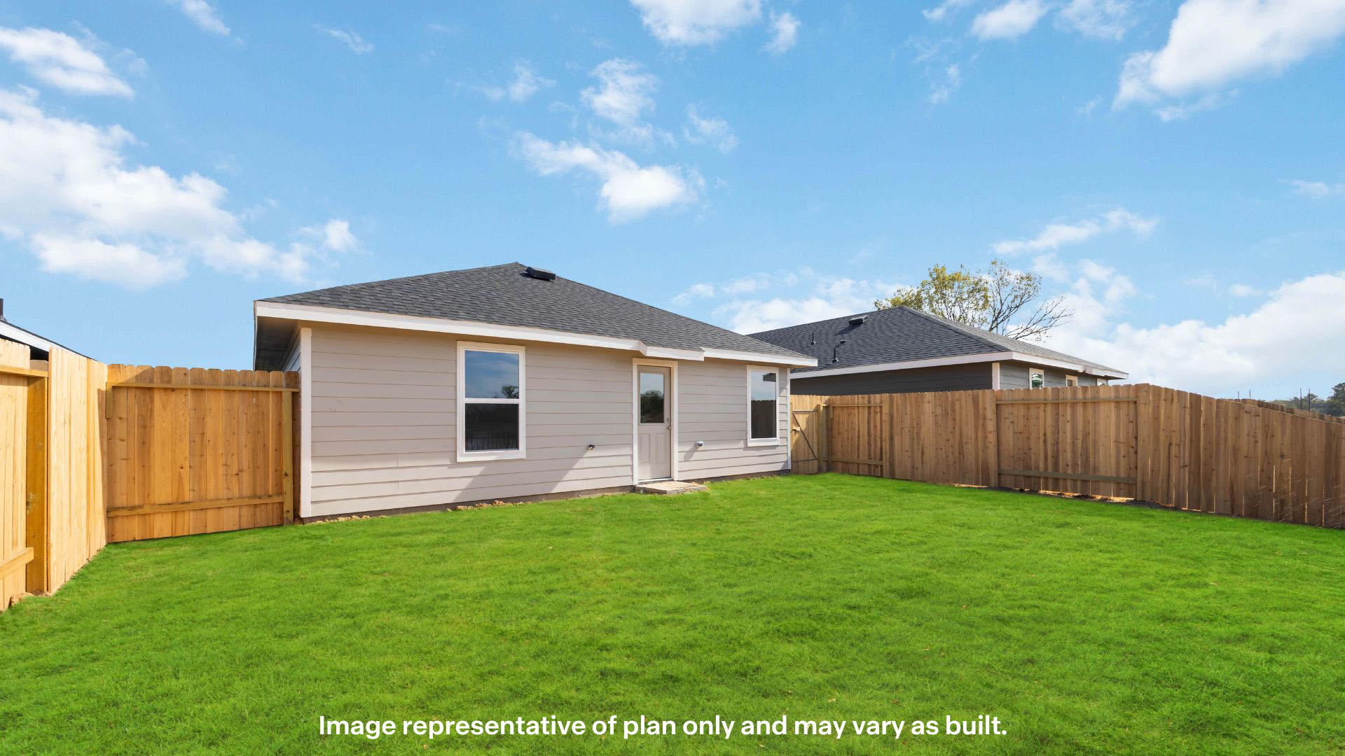 Covered back patio area overlooking spacious backyard