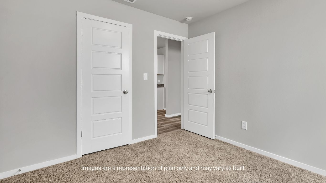 The secondary bedroom offers a versatile space ideal for guests, family members, or a home office.