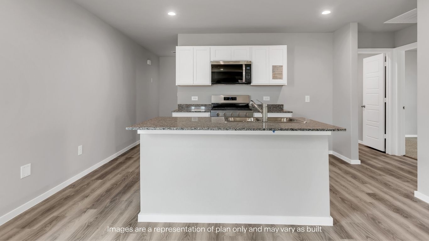 The open-concept kitchen features a large center island, stainless steel appliances, and ample cabinet space