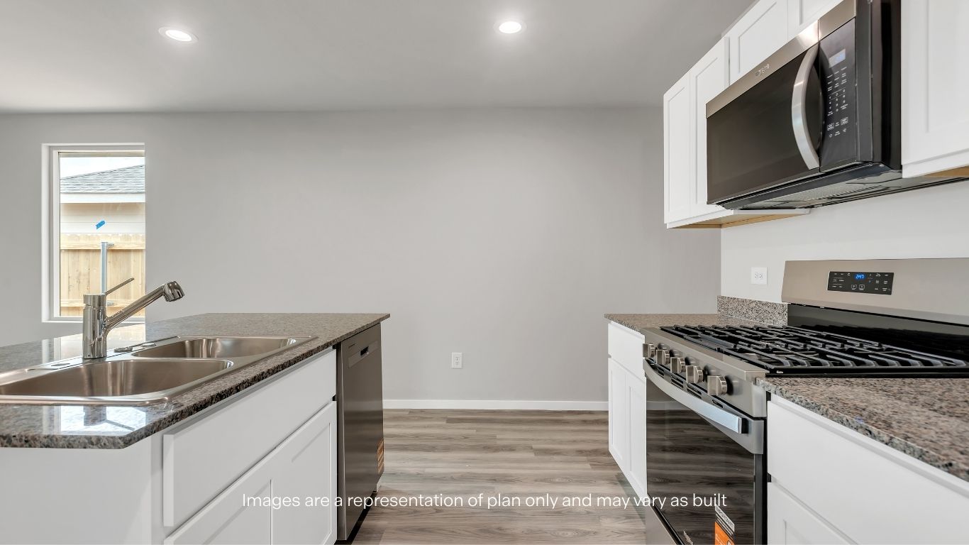 Designed for everyday living, the kitchen offers granite countertops, modern cabinetry, and seamless flow into the dining area.