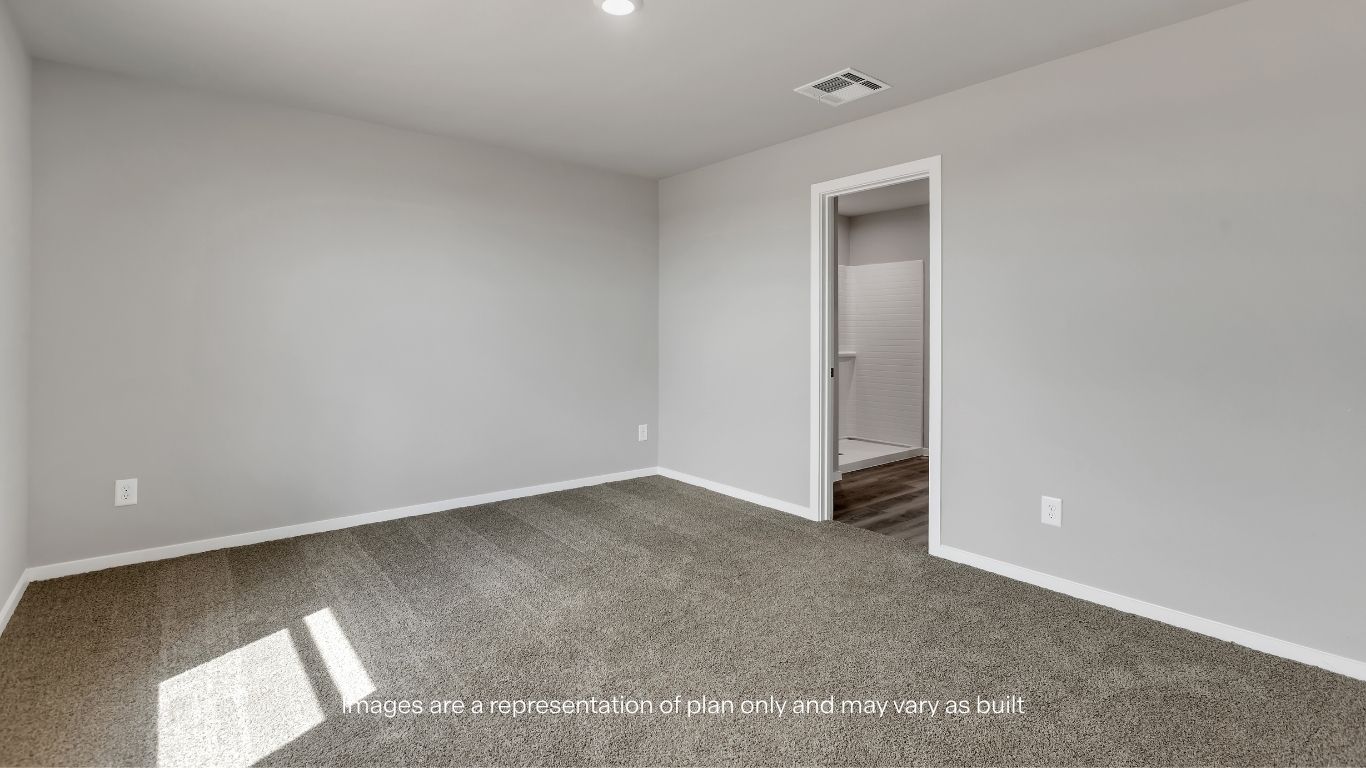 Clean and modern primary bath with a spacious shower and vanity.