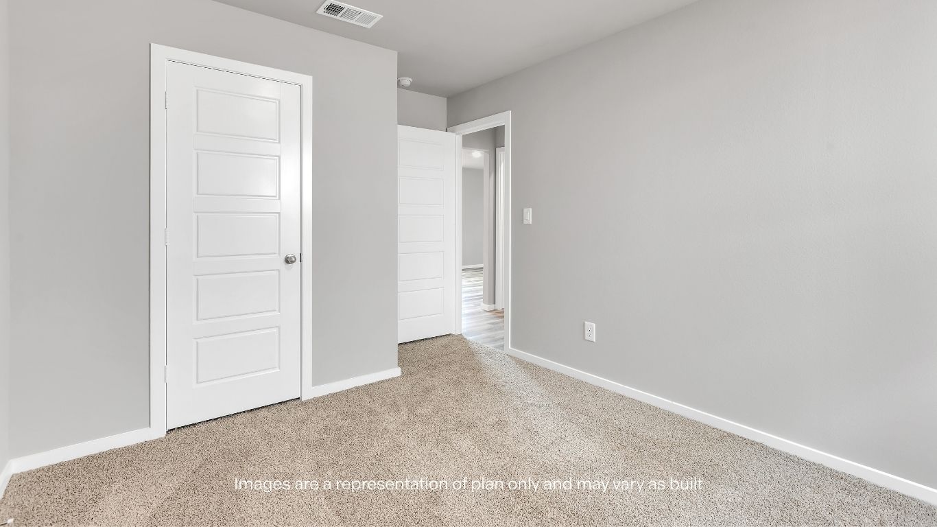 Bright bedroom space with cozy carpeting and natural light.