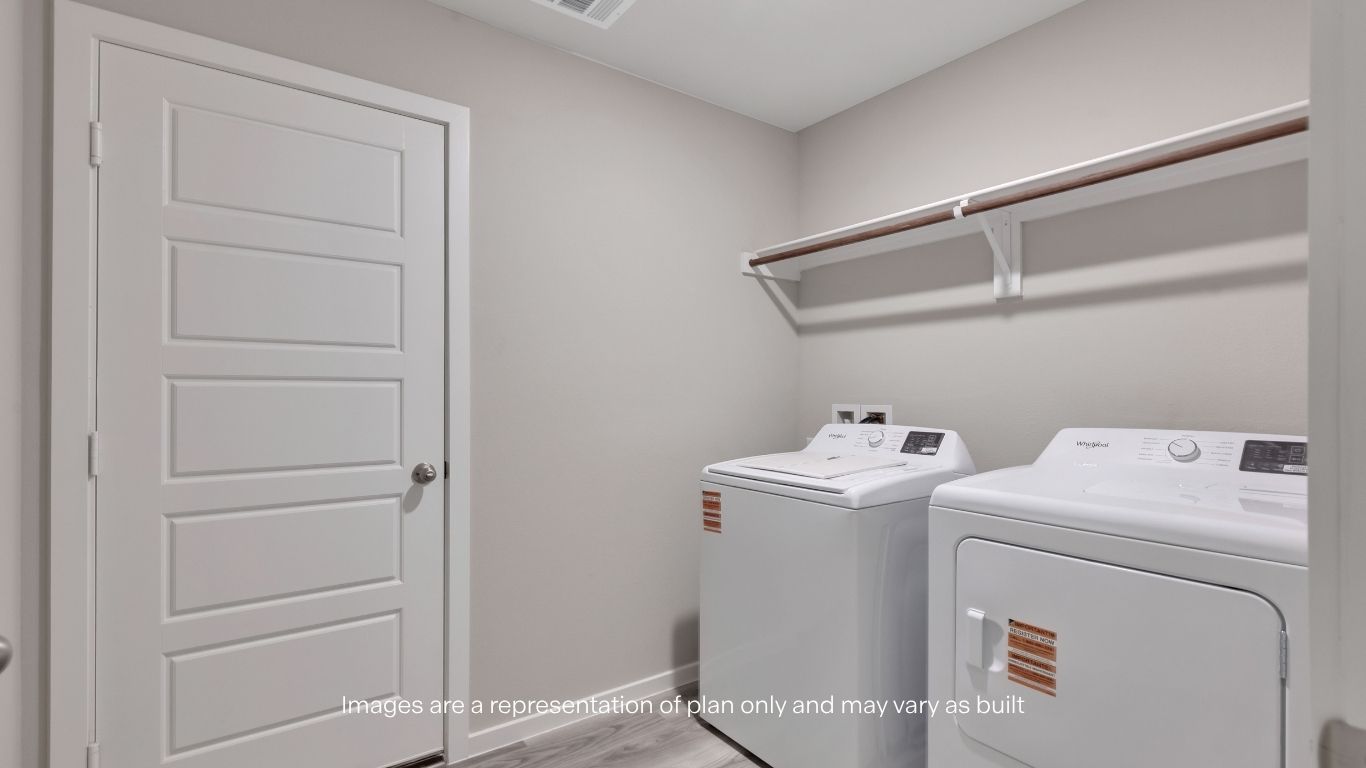 Dedicated laundry room with washer/dryer connections and built-in shelving for added storage.