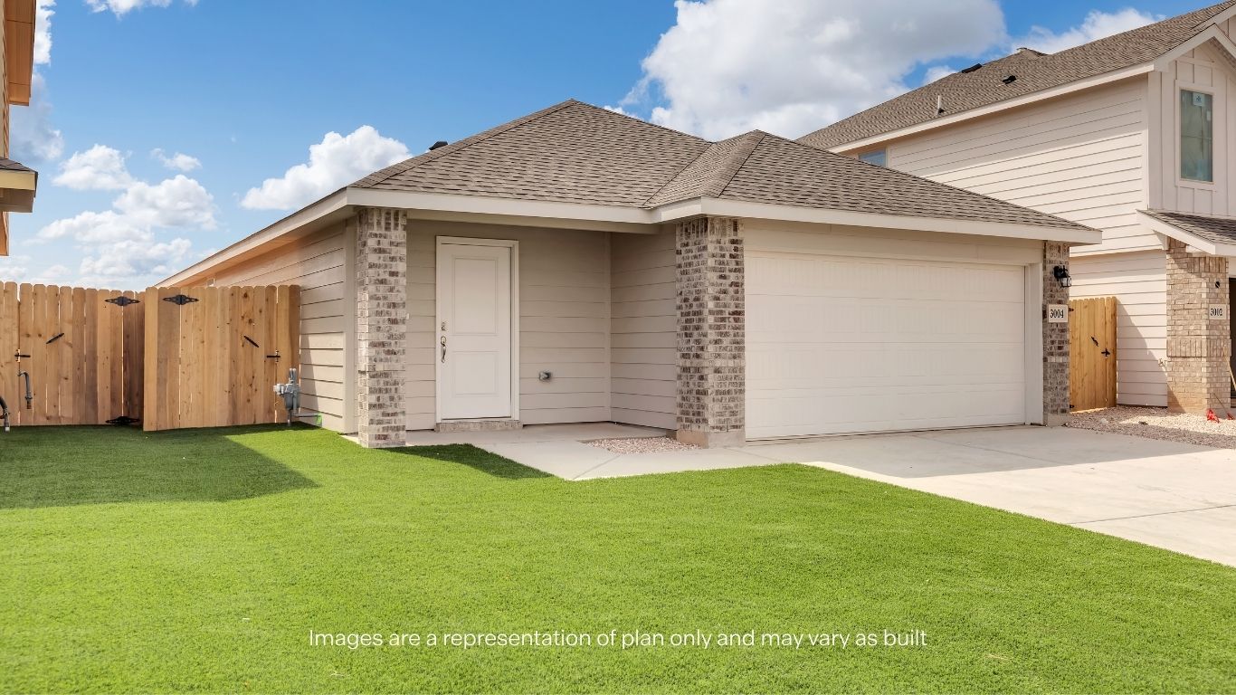 Great curb appeal featuring a spacious driveway and welcoming entry.