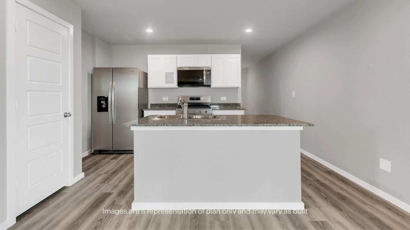 Modern kitchen with stainless steel appliances, sleek countertops, and ample cabinet space.