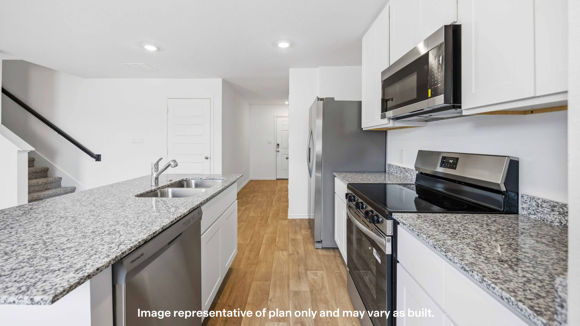 Open concept kitchen with stainless steel appliances, shaker style cabinets, and elevated finishes
