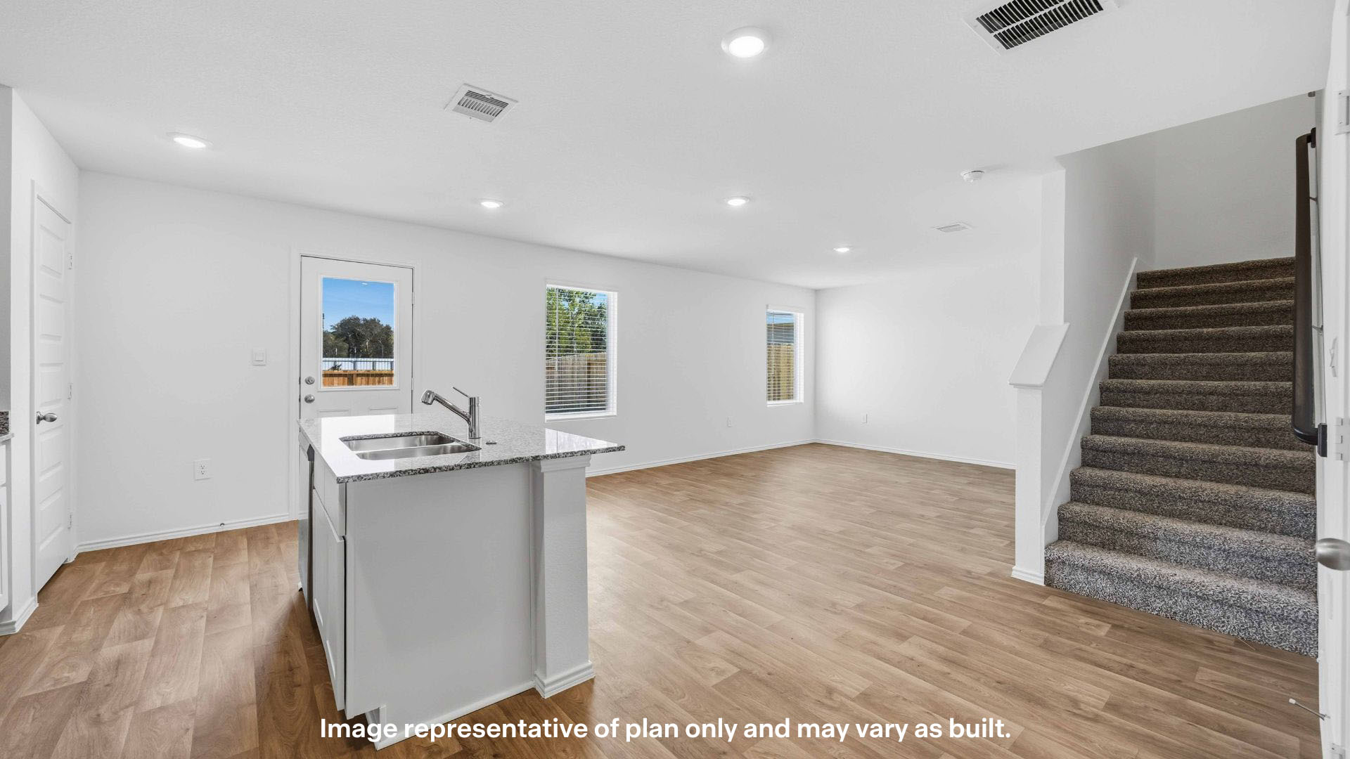 Spacious living and family room space with light allowing windows