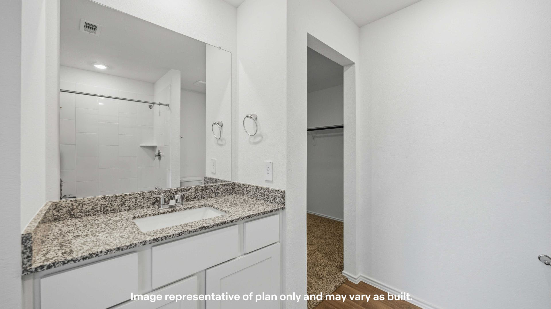 Primary bathroom with built in vanity and luxurious shower