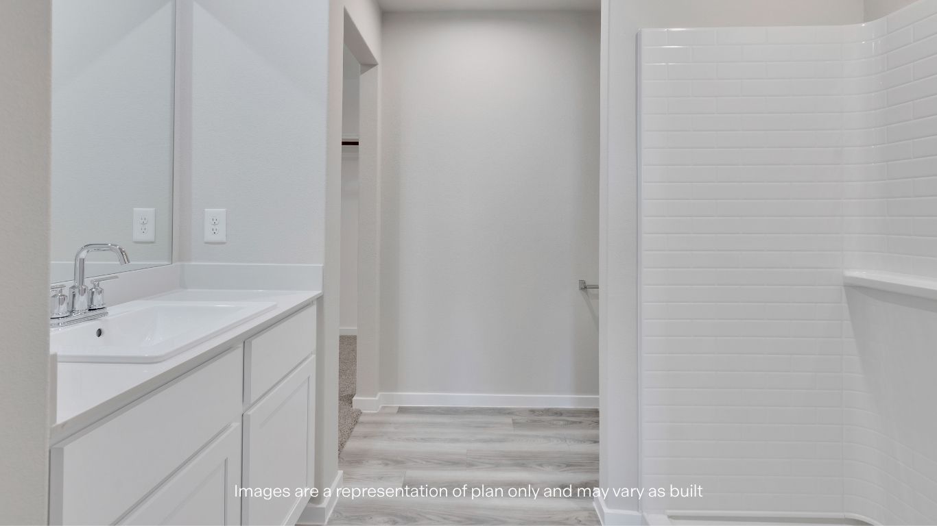 The private primary bathroom features a stylish vanity, contemporary finishes, and easy access to the spacious walk-in closet.