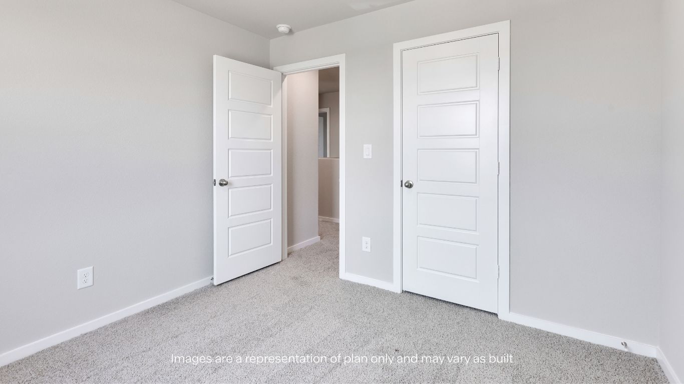 One of two versatile secondary bedrooms featuring plush carpet flooring, natural light, and closet space ideal for guests, family, a home office, or flex room.