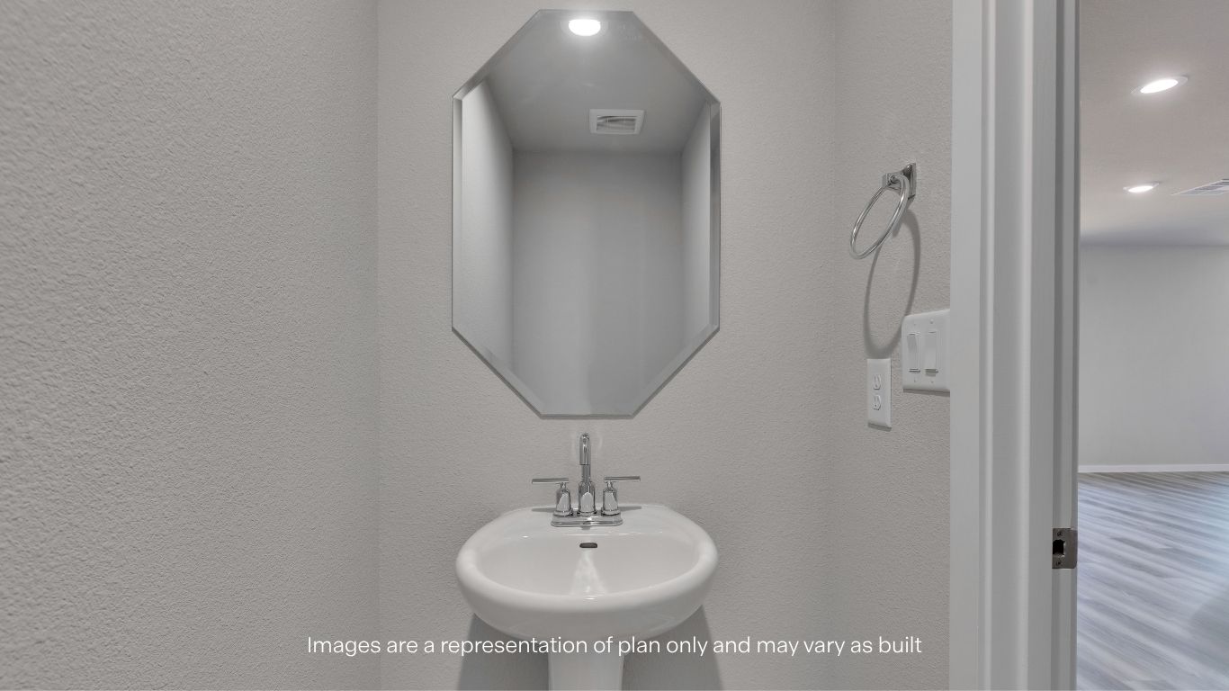 The first-floor powder bath offers a clean and functional design, perfect for guests and everyday convenience.