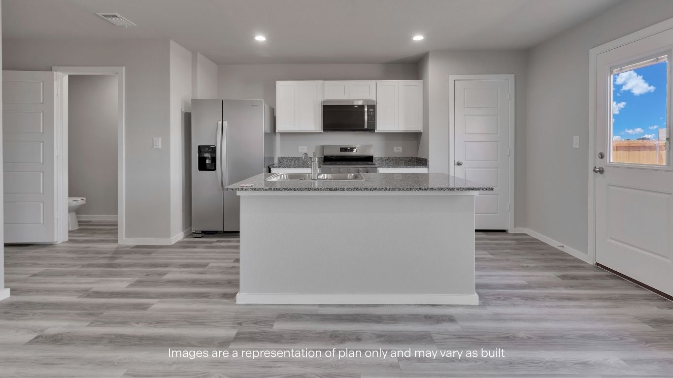 The spacious kitchen island provides additional prep space, seating opportunities, and serves as the heart of the home's main living area.