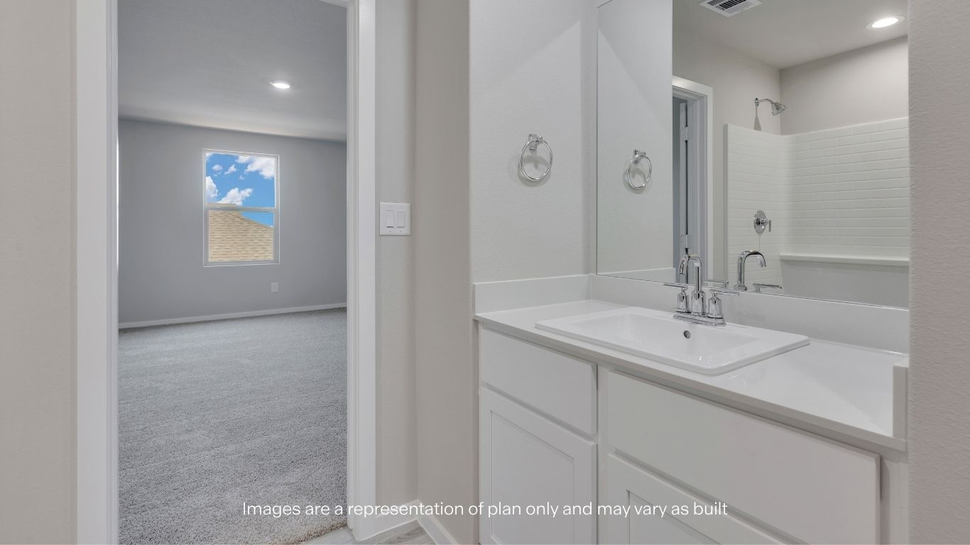 The upstairs primary bedroom provides a peaceful retreat with plush carpeting and plenty of room for comfortable furnishings.